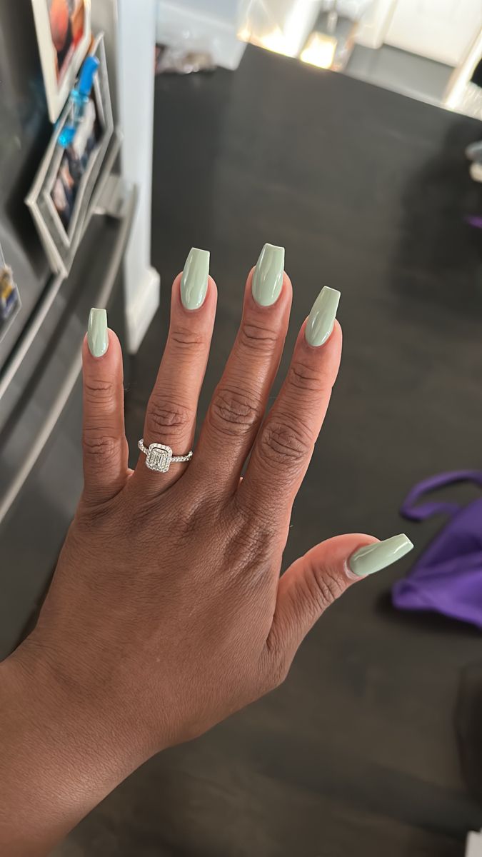 Chic Long Square Nail Design with Soft Green Polish and Silver Ring Accent