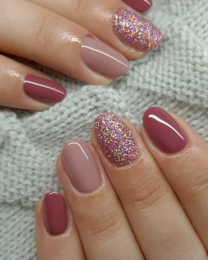 Sophisticated Muted Pink Nail Design with a Playful Glitter Accent.