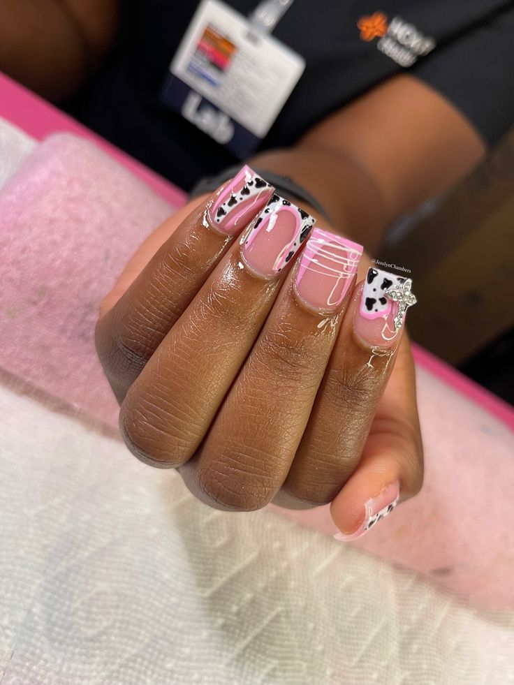 Playful Pink Nail Design with Stripes and Abstract Patterns for Individuality.