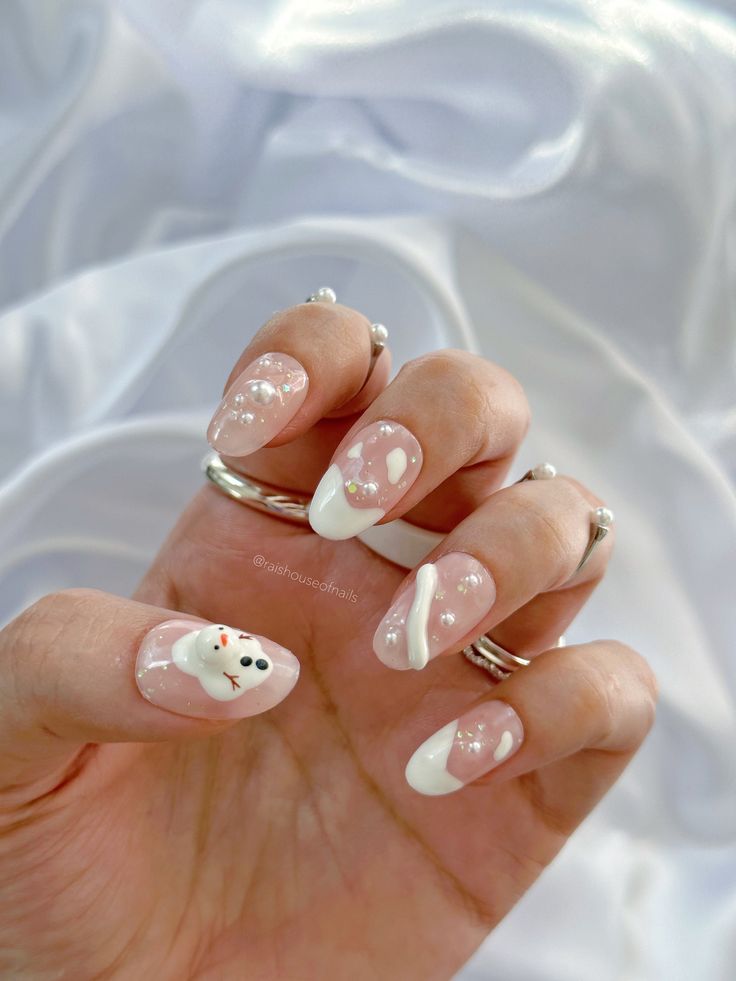 Whimsical Winter-themed Nail Design with Soft Pink Base and Festive Accents