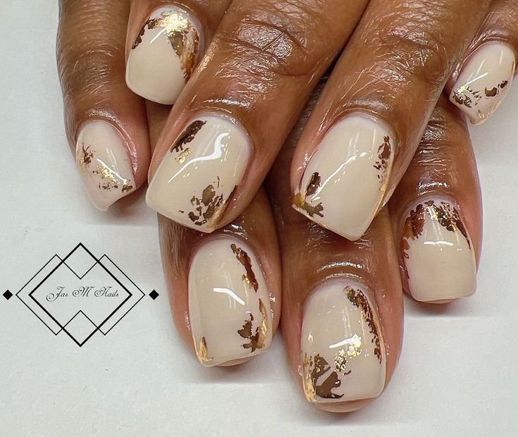 Chic Elegant Nail Design: Neutral Base with Gold Leaf Accents