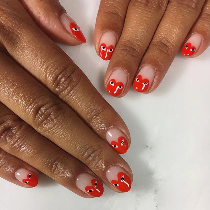 Vibrant Bold Red Nail Design with Playful Hearts for a Whimsical Statement.