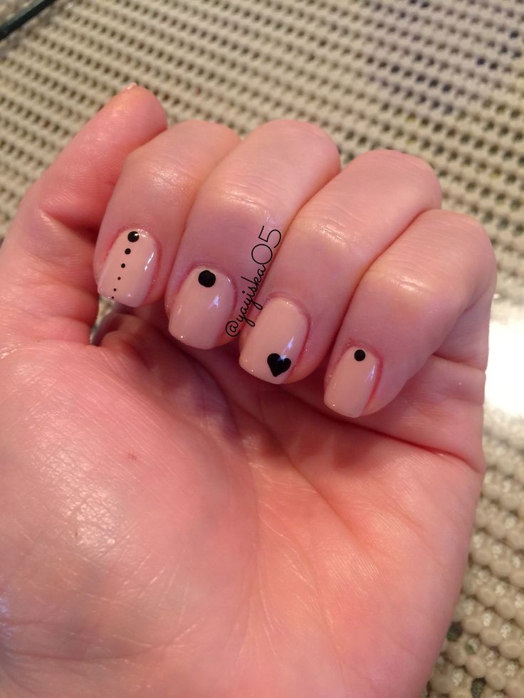 Minimalist Nail Art: Soft Neutral Base with Playful Black Shapes and Heart Accents