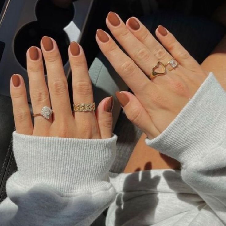 Chic Neutral Matte Nails with Elegant Rings for a Cozy Aesthetic.