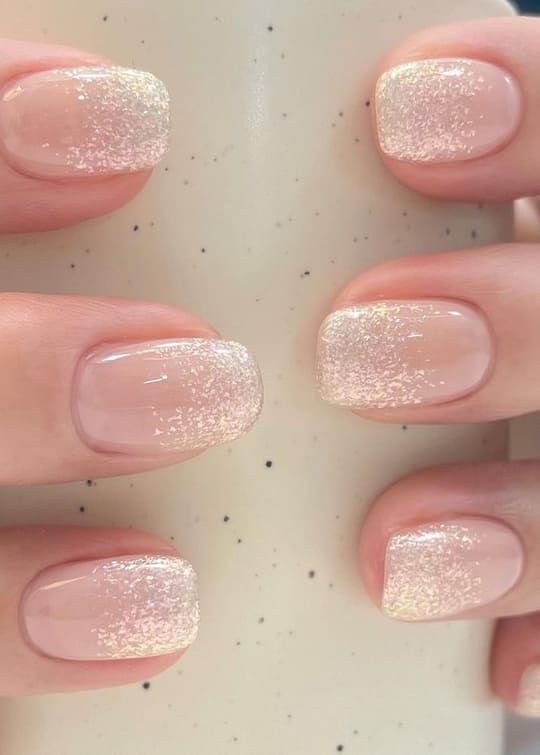 Elegant Nude Nail Design with Shimmering Glitter Tips for Versatile Occasions.