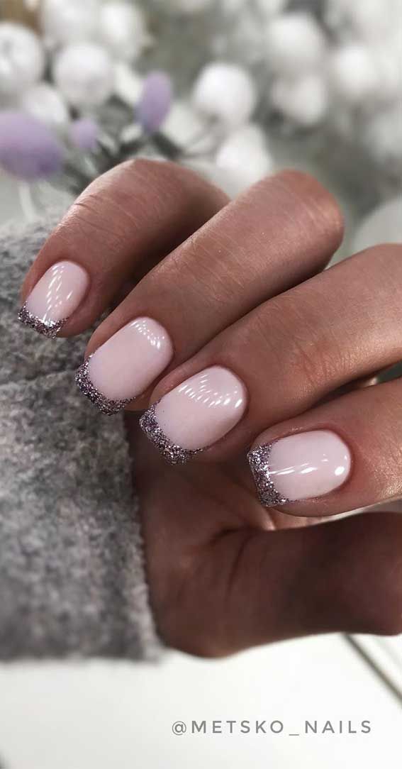 Elegant Nude Nail Design with Glamorous Silver Glitter Tips Perfect for Any Occasion.