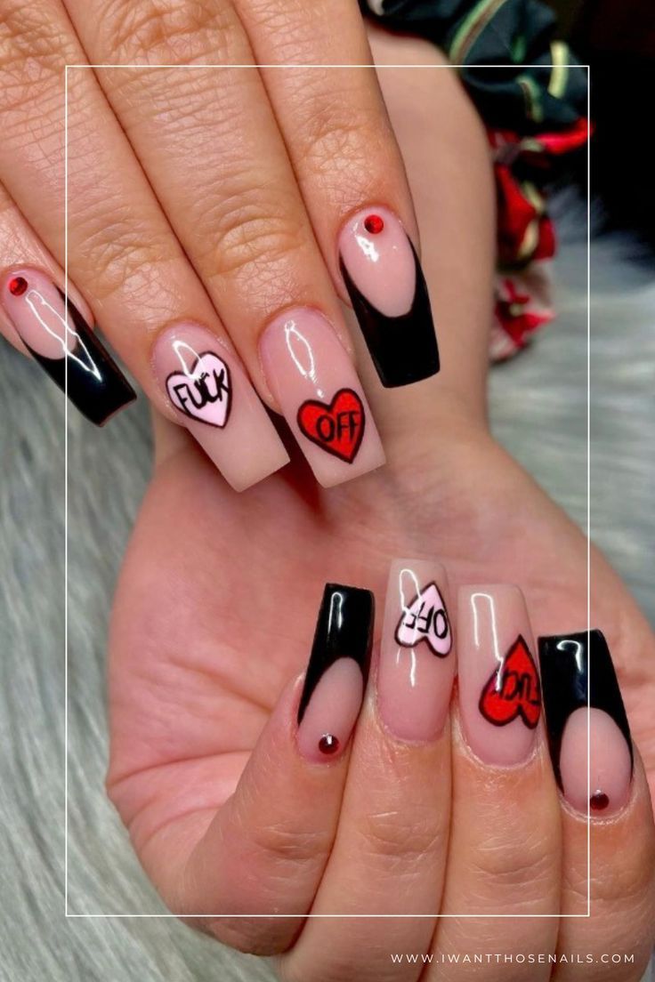 Edgy Chic: Bold Nude and Black Heart-Shaped Nail Design with Red Gem Accents