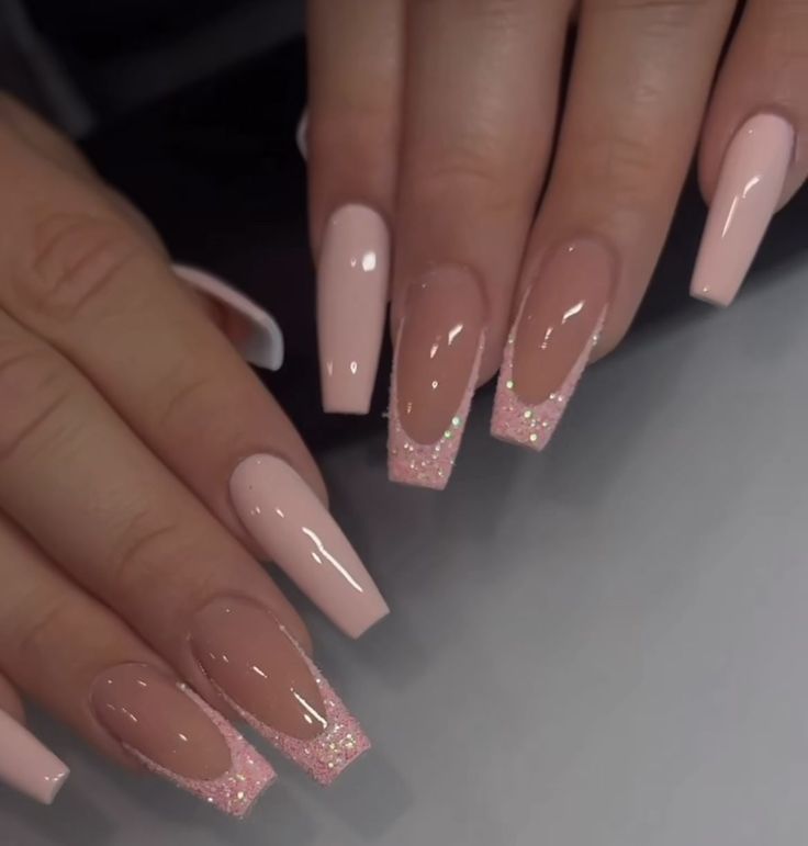 Chic Soft Pink and Nude Nail Design with Glitter Accents for a Modern Look.