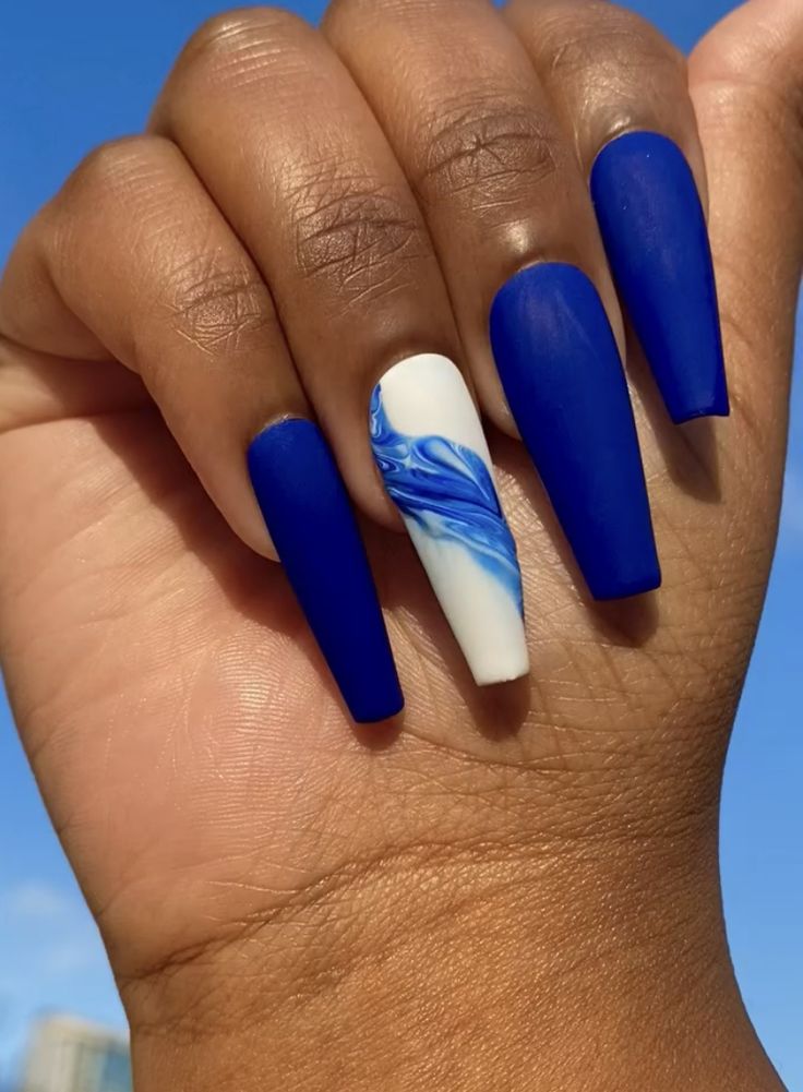 Bold Striking Blue Nail Design with Glossy Finish and Intricate White Marbling Accent.