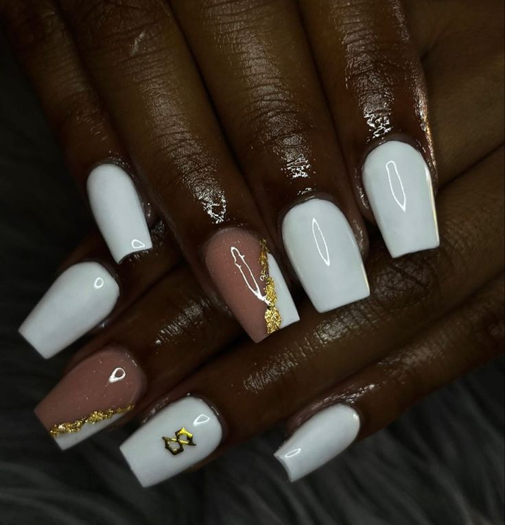 Chic Glossy White and Nude Nail Design with Gold Foil Accents.