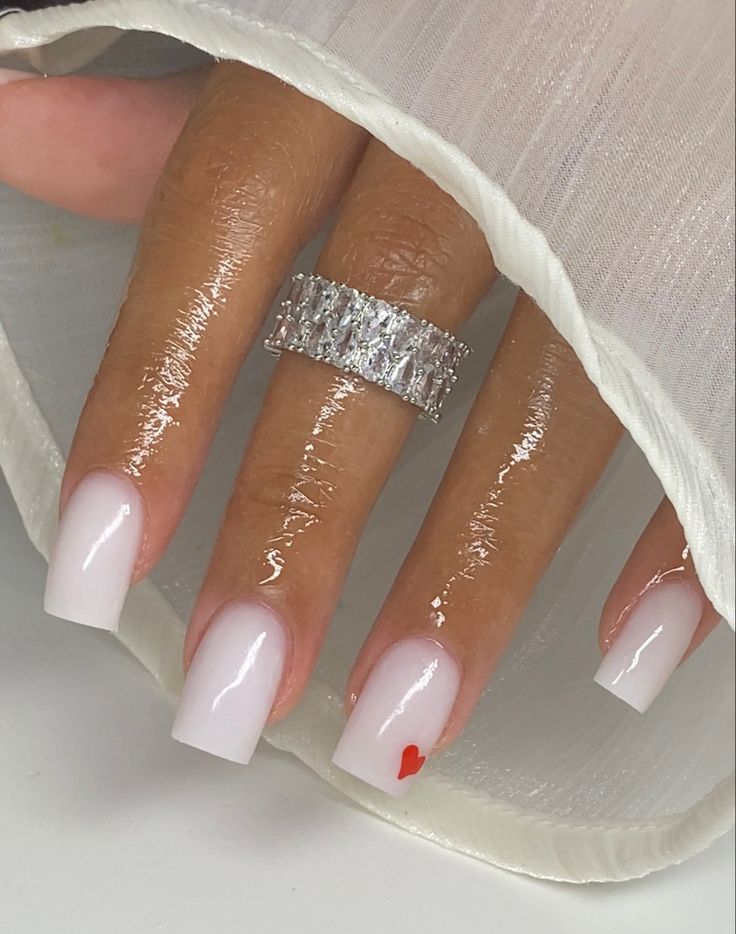 Chic Ombre Nail Design with a Playful Heart Accent and Sparkling Statement Ring.