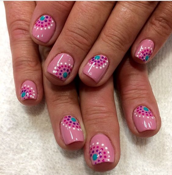 Chic Delicate Pink Nail Design with Floral Patterns and Bold Turquoise Magenta Accents.