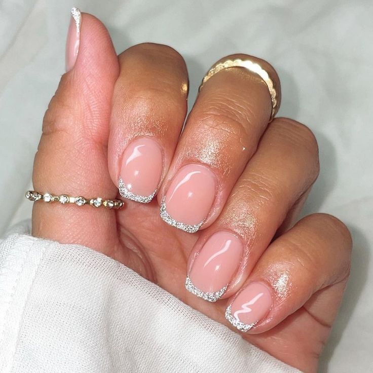 Sophisticated Elegant French Tips with Subtle Nude Base and Sparkling Silver Accents.