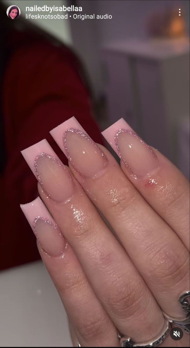 Elegant Soft Pink Acrylic Nails with Glitter Accents and Modern Square Shape.