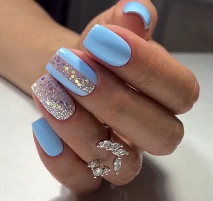 Whimsical Soft Blue Nail Design: Elegant Matte and Glitter Blend for Any Occasion