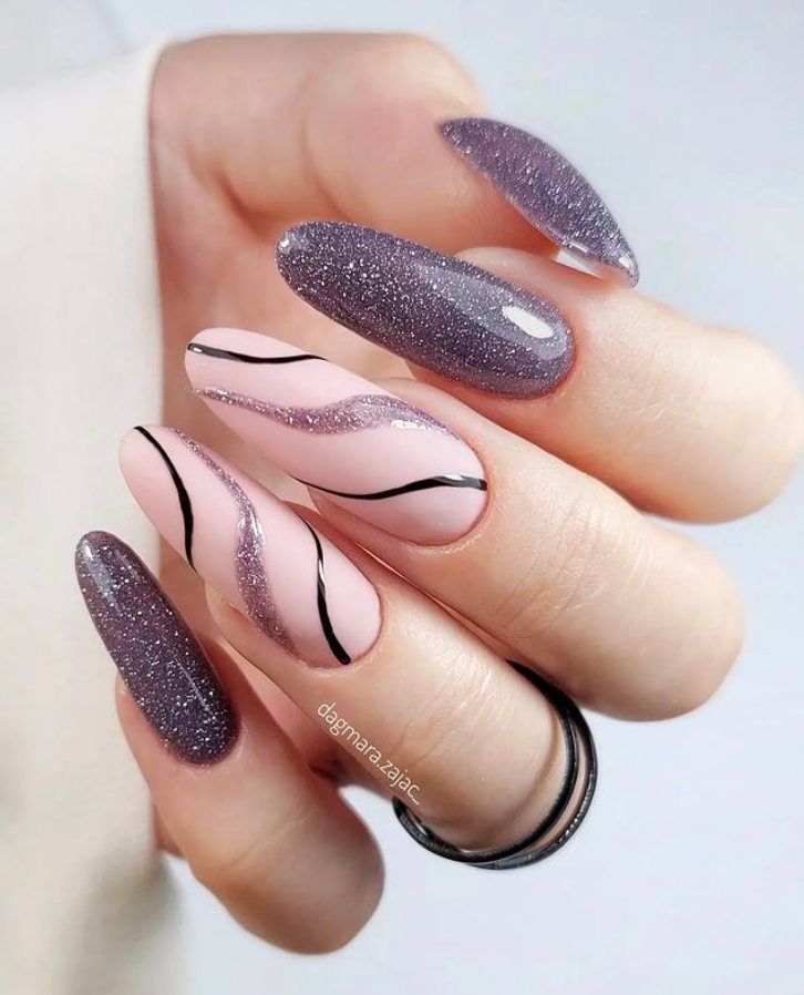 Sophisticated Nail Design: Glossy Pink Base with Glamorous Purple Glitter and Sleek Black Accents.