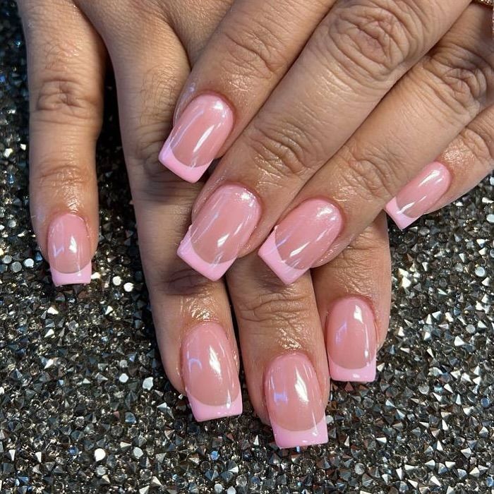 Chic Soft Pink Nail Design with Delicate French Tips for a Polished Look.