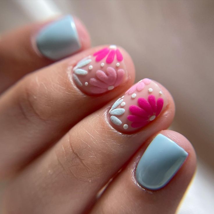 Cheerful Floral Nail Design with Vibrant Pinks and Pastel Daisies