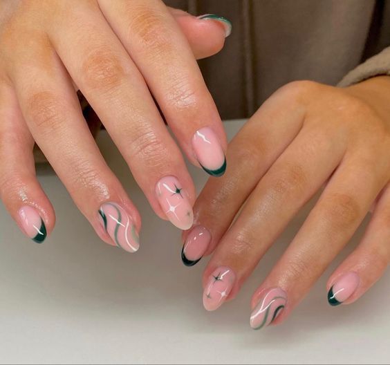 Sophisticated Soft Pink Nail Design with Intricate Swirls and Dark Green Tips.