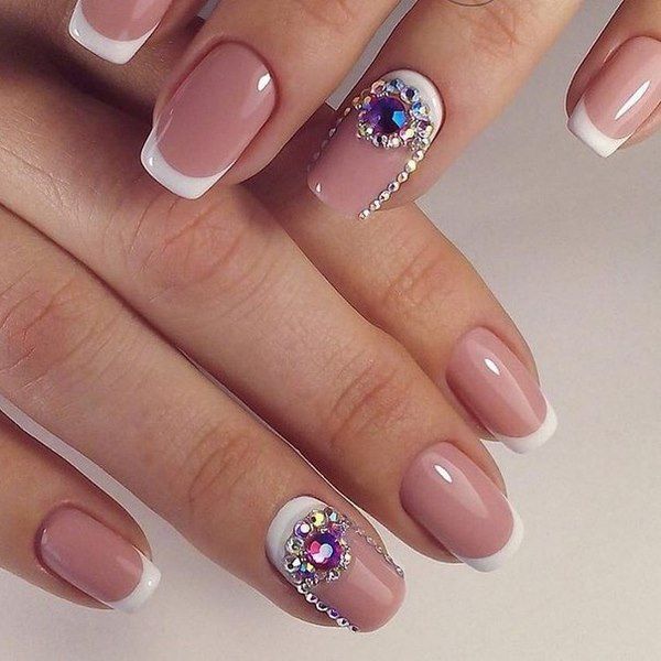 Chic French Manicure with Nude Base and Sparkling Embellishments for Glamorous Occasions.