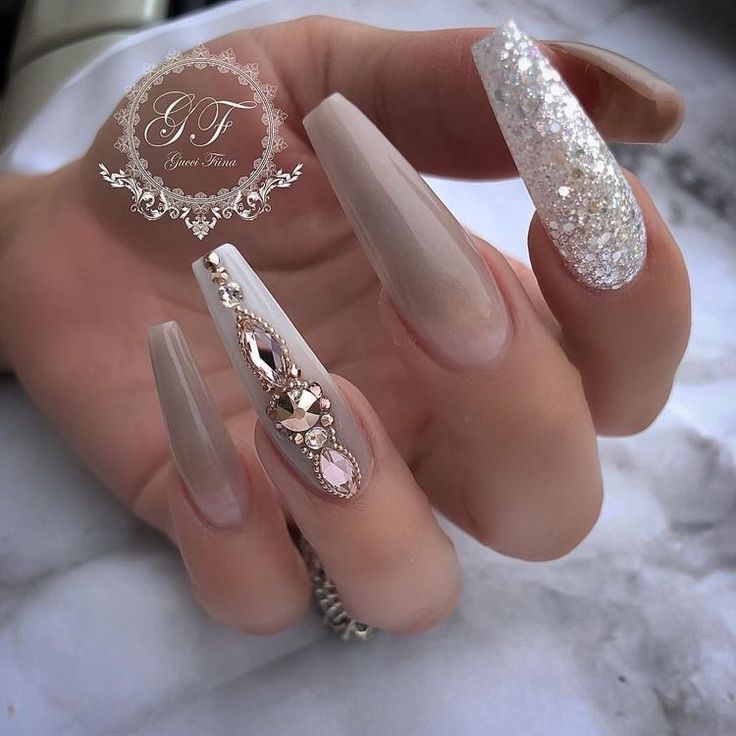 Sophisticated Coffin Nail Design with Nude Base and Glamorous Glitter Accents.