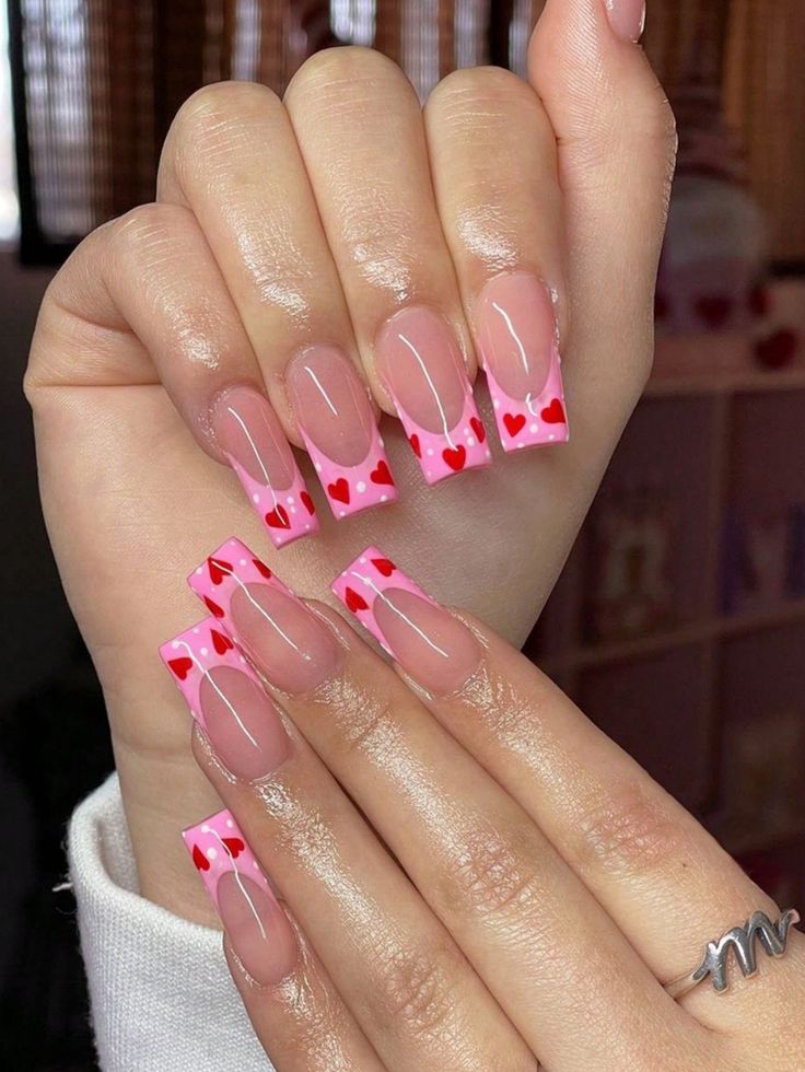 Playful and Romantic Heart-Accent Nail Design with Soft Pink Base and Delicate White Outlines