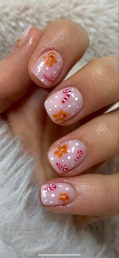 Whimsical Festive Nail Design with Soft Pink Base and Winter-Themed Accents