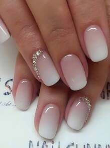 Elegant Ombre Nail Design: Soft Pink to White Gradient with Shimmering Rhinestones.