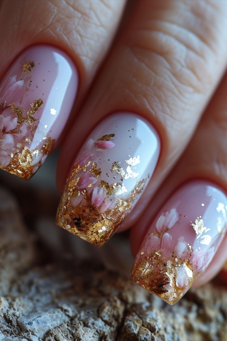 Chic Pink Floral Nail Art with Gold Foil Accents for a Fresh, Glamorous Look.