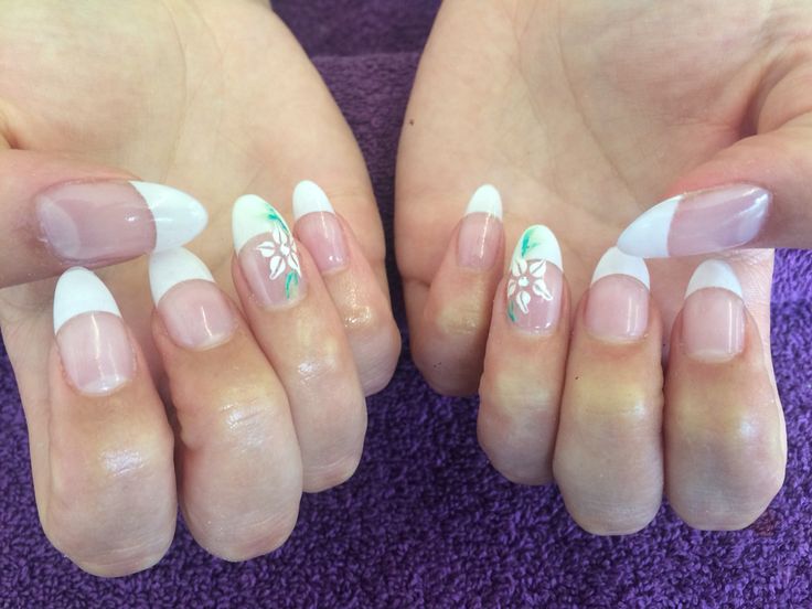 Chic French Manicure with Floral Accents: Sophisticated and Playful Elegance.