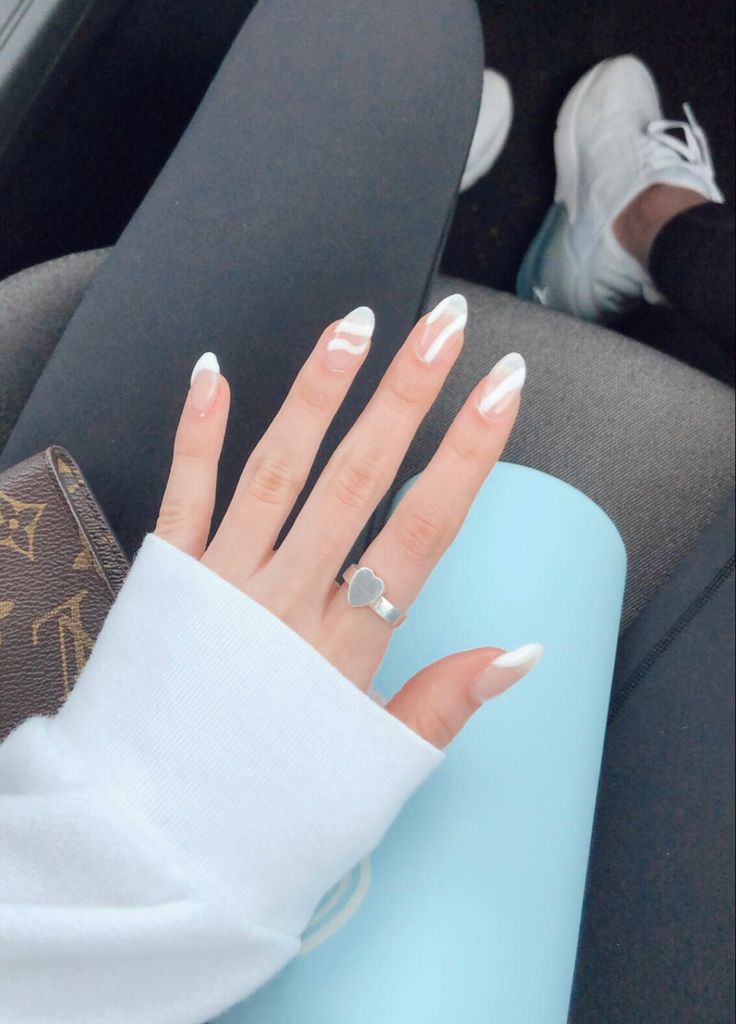 Chic Marble-Inspired French Tip Nail Design with Minimalist Jewelry.