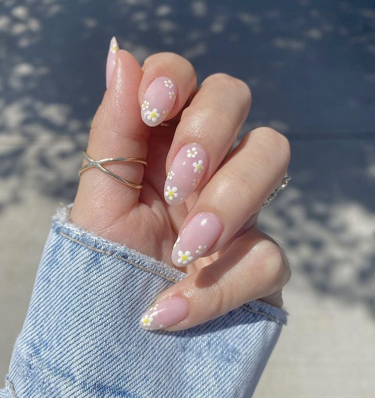 Elegant Floral Nail Design with Soft Pink Base and Delicate White Daisies for a Whimsical Spring Vibe.