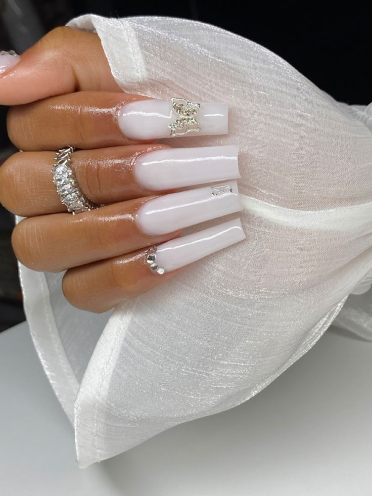 Sophisticated Chic: Glossy White Long Nails with Sparkling Embellishments and Intricate Art