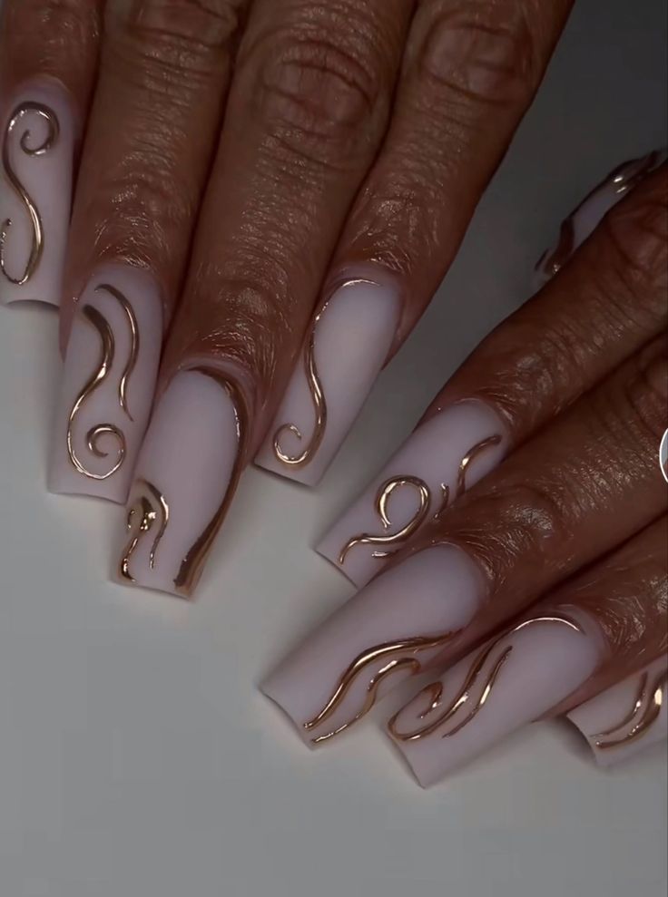 Sophisticated Nail Design: Soft Matte Base with Elegant Gold Accents