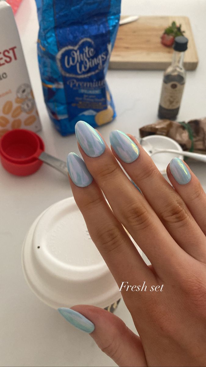 Elegant Iridescent Blue Almond Nails for a Modern, Eye-Catching Manicure.