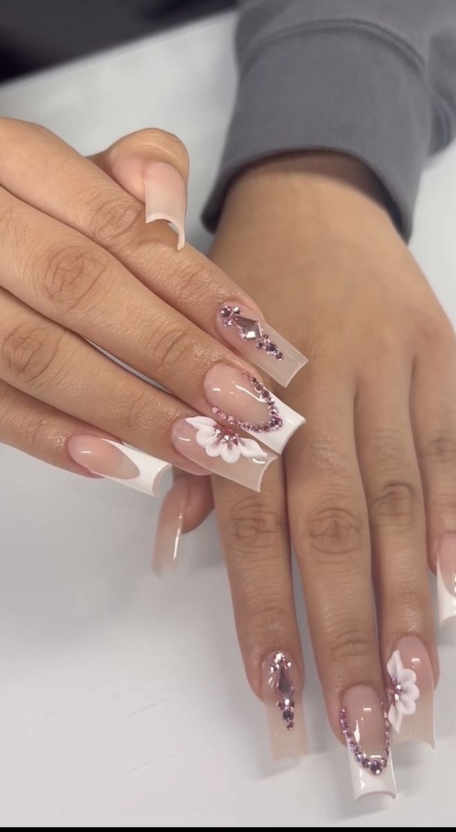 Chic Elegant Nail Design: Classic French Tips with Floral Motifs and Rhinestones.