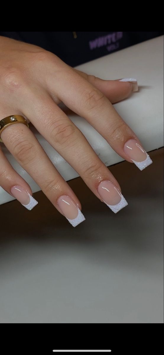 Chic Nail Design: Soft Nude Base with Elegant White Tips and Textured Finish.