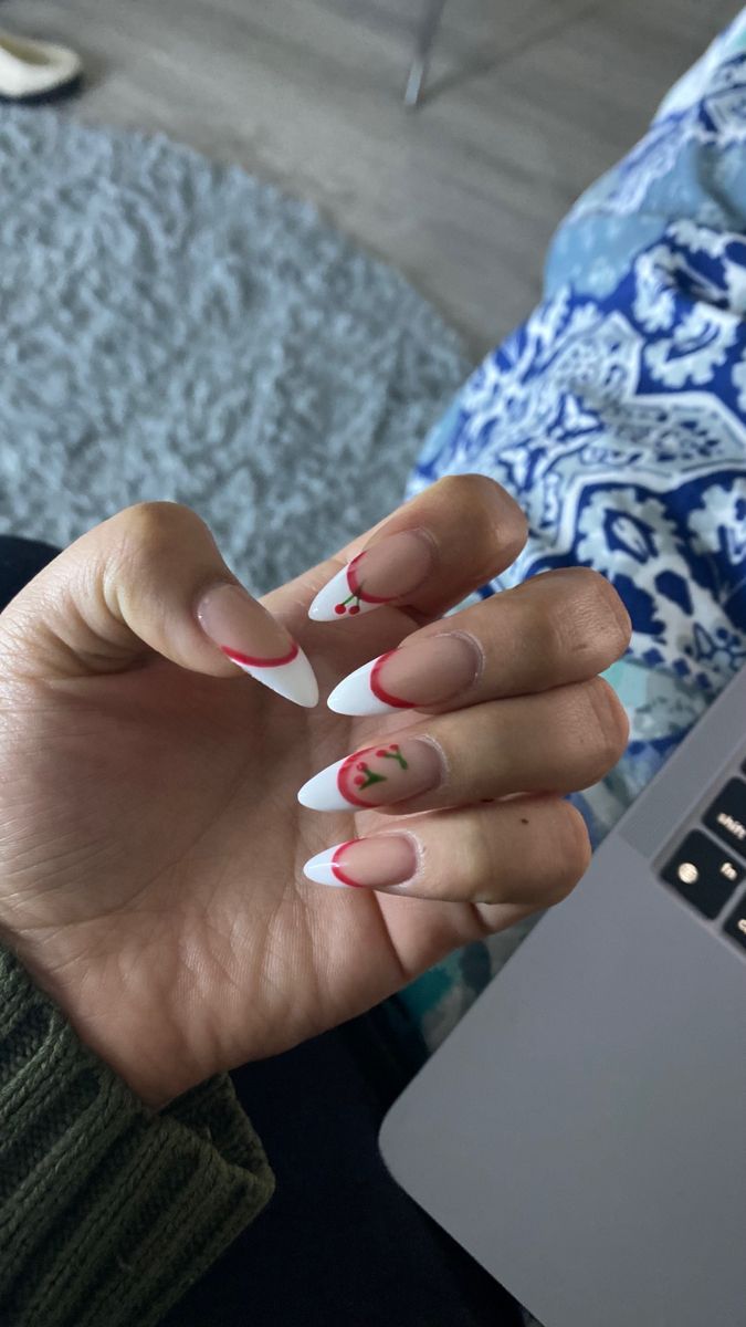 Chic French Tip Nail Design with Playful Red Accents and Cherry Motifs for a Fun Summer Vibe.