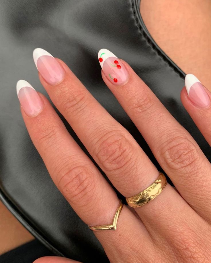 Chic French Manicure: Elegant White Tips, Soft Nude Base, Festive Red Dots, and Subtle Green Accents.