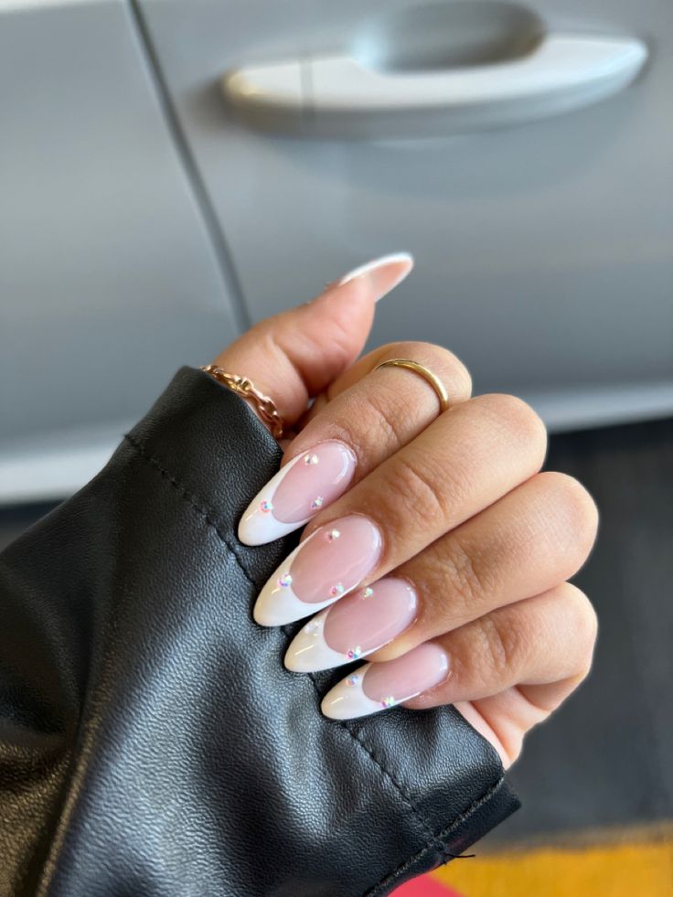 Chic Almond-Shaped Nails with Pink Base, White Tips, and Sparkling Gems for a Modern Look.