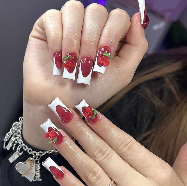 Chic Cherry-Themed Nail Design: Bold Red with Elegant White Tips and Glossy Accents.