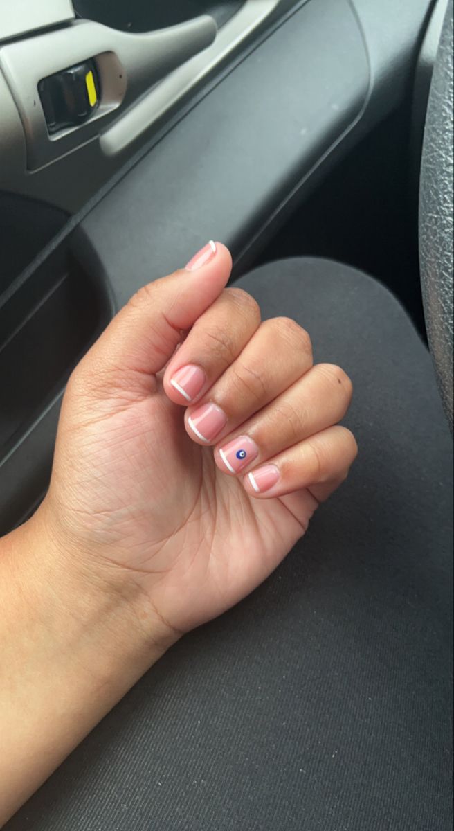 Elegant Nude Nails with Subtle French Tips and Playful Blue Dot Accent.