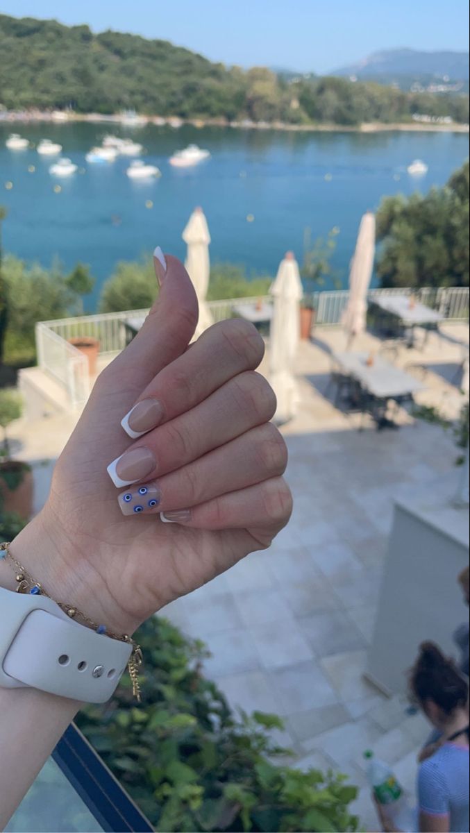 Chic Summer French Tip Nails with Playful Blue Dot Accents.