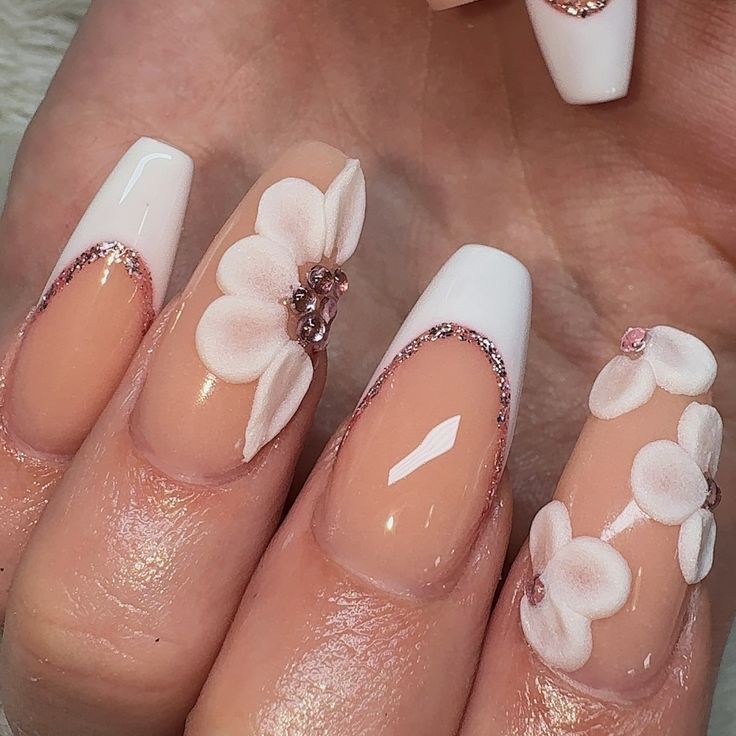 Chic Floral Nail Design with Nude and White Tips Enhanced by Gems and Glitter