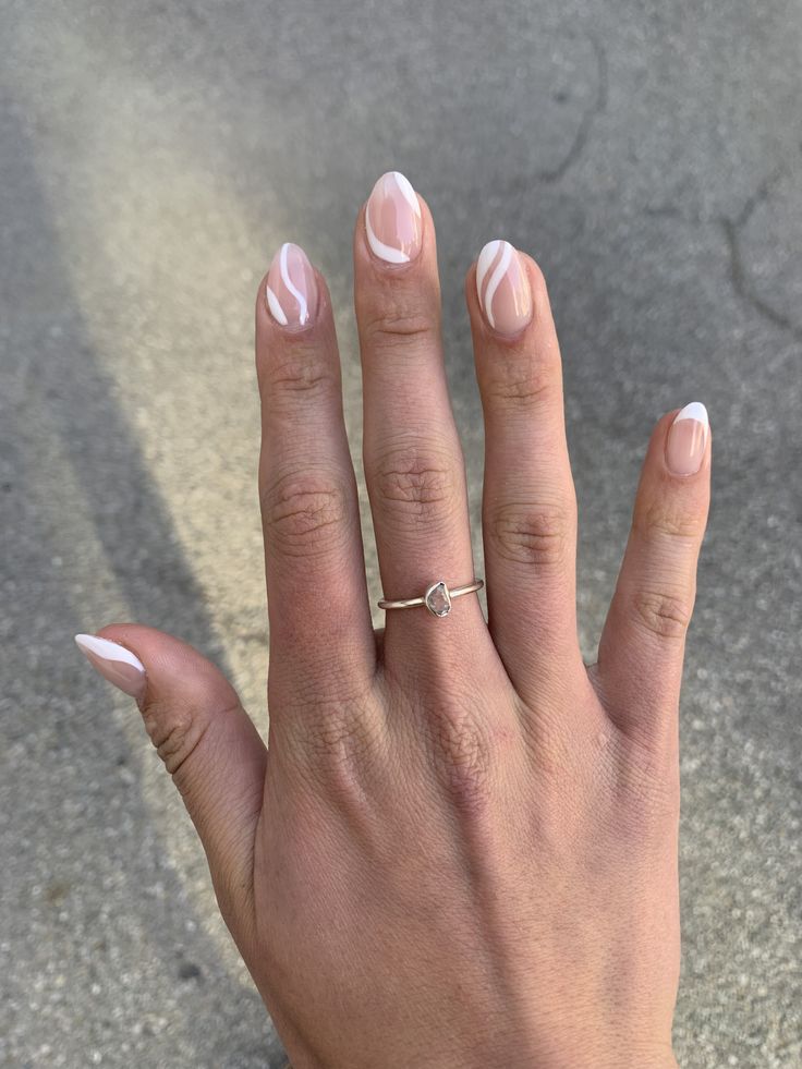 Sophisticated Nude Nail Design with Delicate White Swirls for Any Occasion.