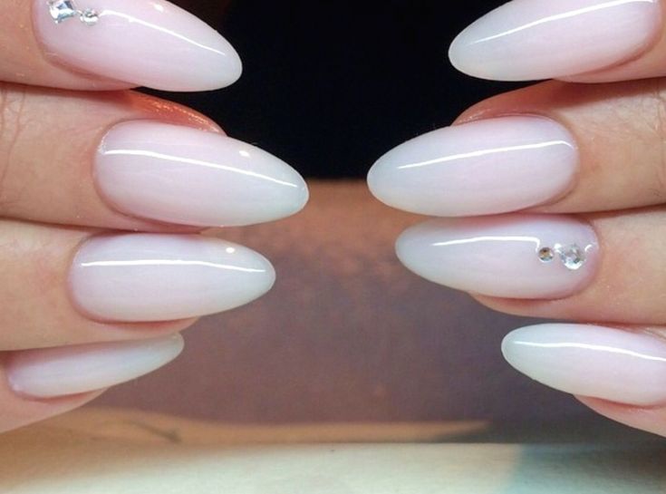 Elegantly Crafted Ombre Almond Nails with Feminine Pastel Pink and Subtle Glam Accents.