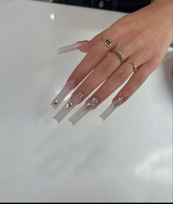 Glamorous Elegant Long Nails with Intricate Embellishments for Special Occasions.