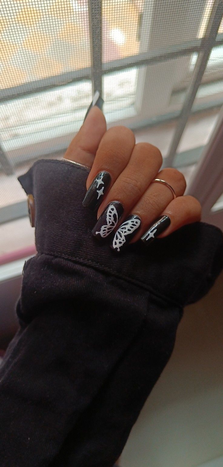 Elegant Black and White Nail Design with Delicate Lace and Star Motifs for All Occasions.