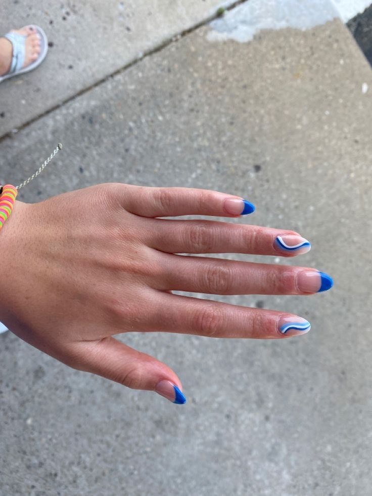 Playful Vibrant Blue Nail Design Blending Shapes and Colors for a Trendy Summer Look.