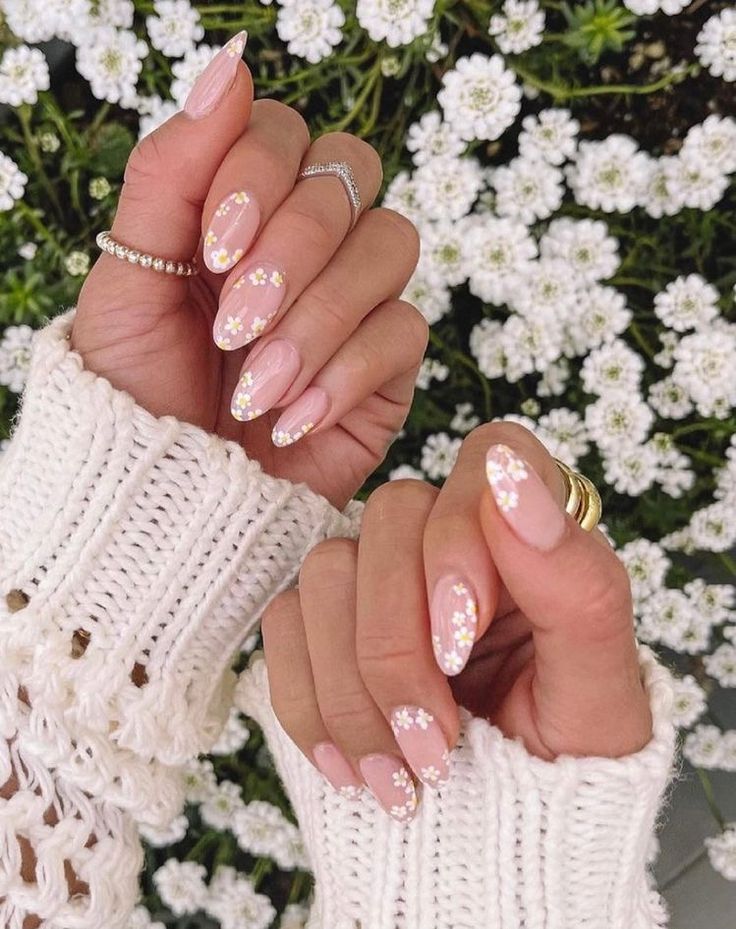 Elegant Almond-Shaped Nail Design with Soft Pink Polish and Floral Accents for a Chic Seasonal Look.